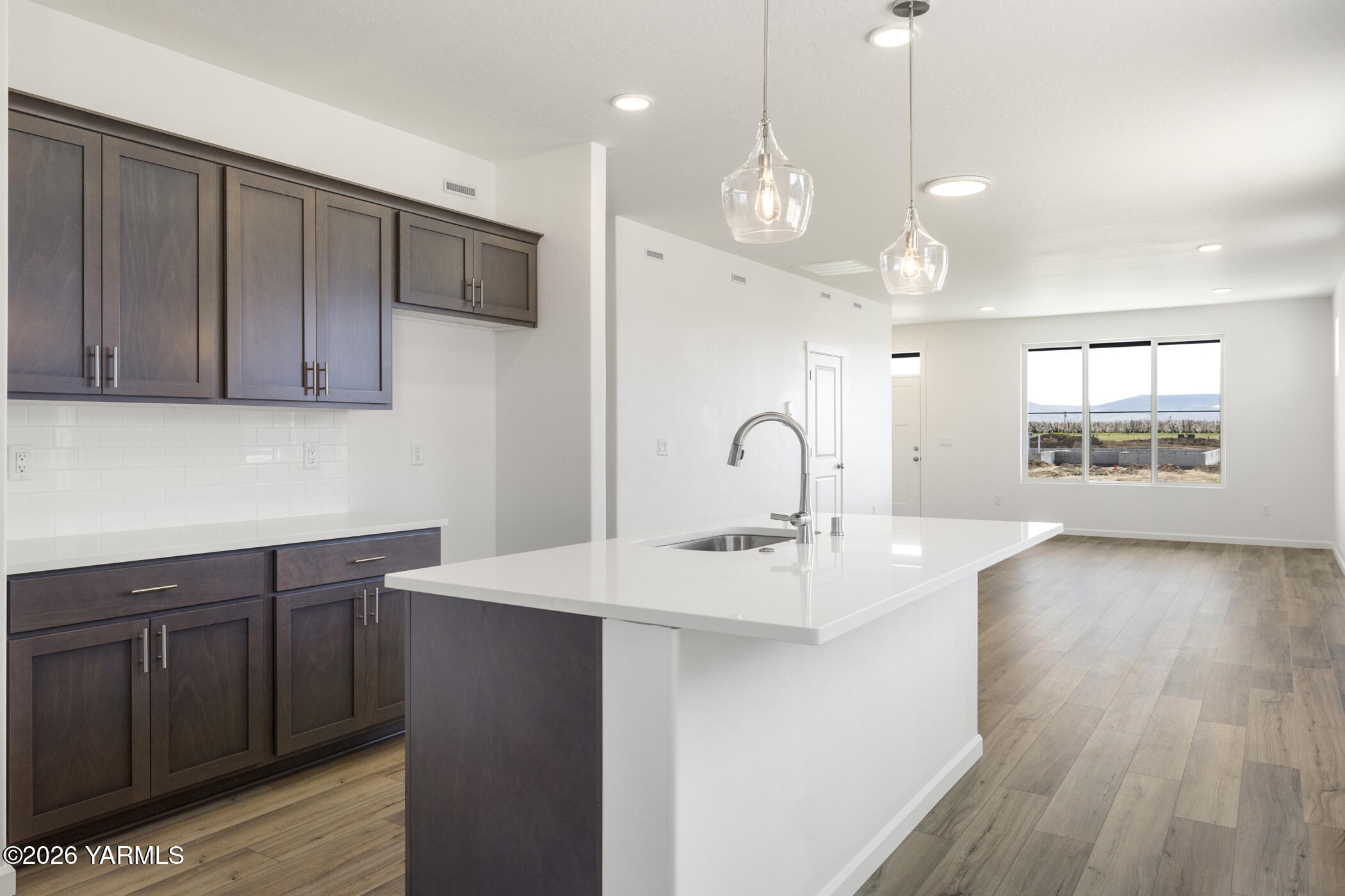 313 Amberly Avenue Grandview, WA 98930 - Photo 9 of 18 a kitchen with kitchen island a sink stainless steel appliances and cabinets