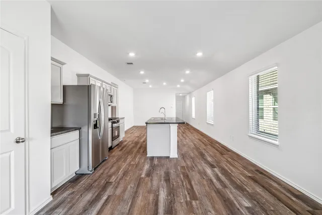 a view of a kitchen with a refrigerator a sink and dishwasher