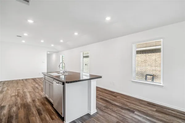 a kitchen with stainless steel appliances granite countertop a sink and a stove top oven