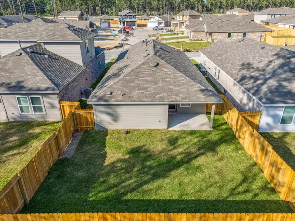 a view of a swimming pool with an outdoor seating and a yard