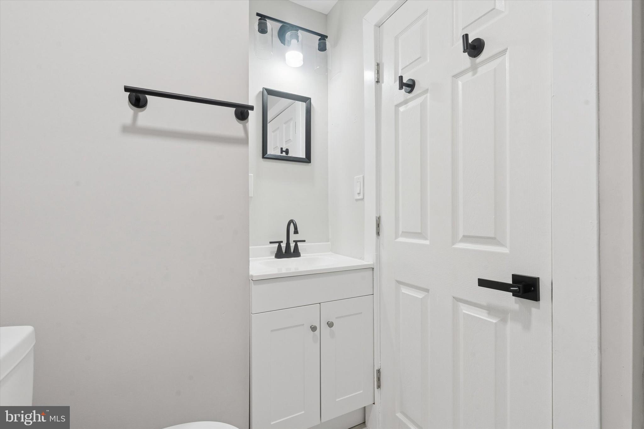3047 Fontain Street Philadelphia, PA 19121 - Photo 14 of 15 a bathroom with a sink and mirror