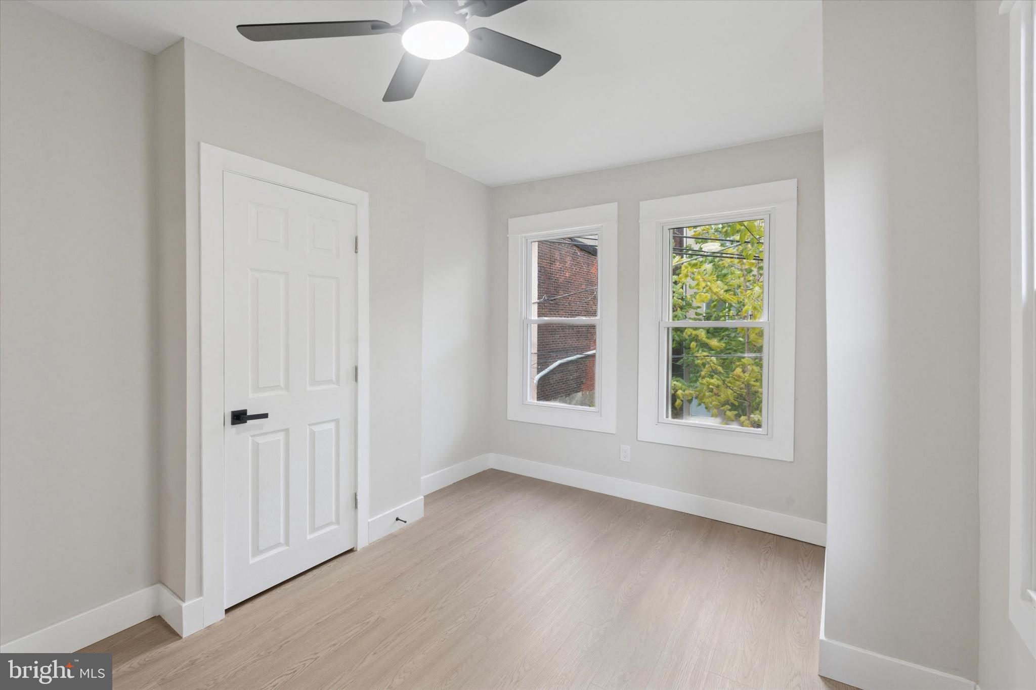 3047 Fontain Street Philadelphia, PA 19121 - Photo 7 of 15 an empty room with wooden floor fan and windows