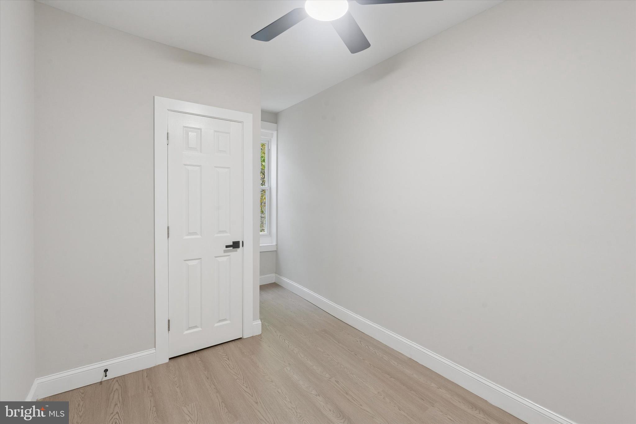 3047 Fontain Street Philadelphia, PA 19121 - Photo 9 of 15 an empty room with a ceiling fan and wooden floor
