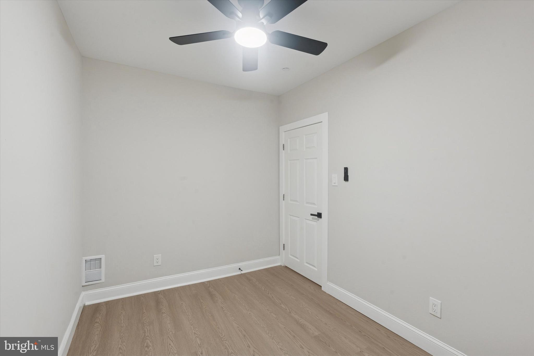 3047 Fontain Street Philadelphia, PA 19121 - Photo 10 of 15 an empty room with a ceiling fan and wooden floor