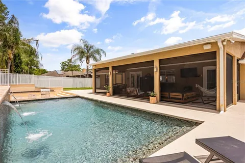 a view of a house with backyard porch and sitting area