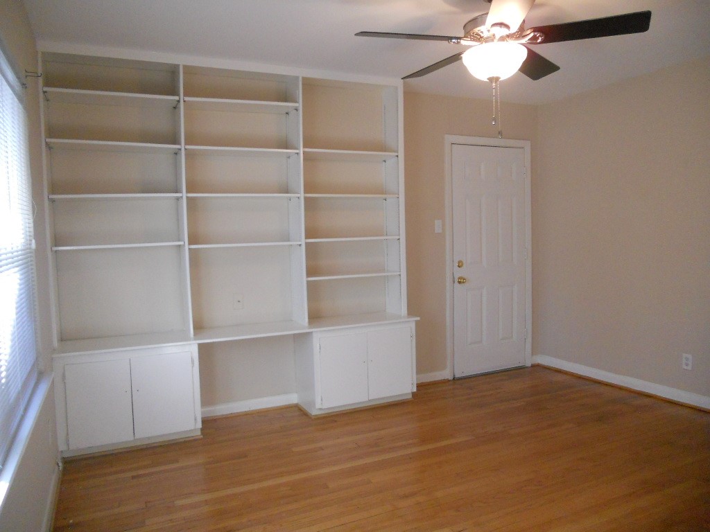 4709 Sanford Road Houston, TX 77035 - Photo 15 of 19 a view of an empty room with a window and wooden floor