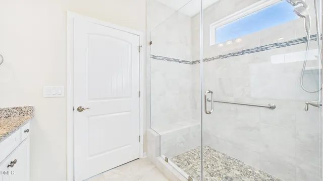 a bedroom with a bed and a refrigerator