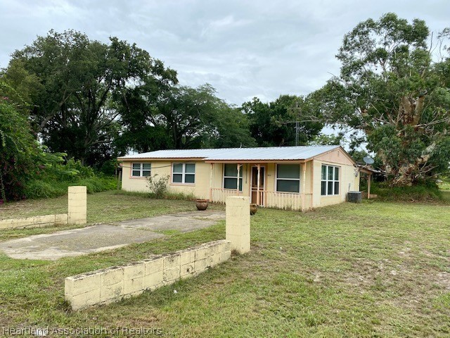 951 Lake June Road Lake Placid, FL 33852 - Photo 2 of 13 a front view of a house with a yard