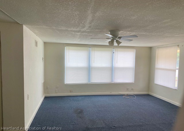951 Lake June Road Lake Placid, FL 33852 - Photo 4 of 13 an empty room with a window and a ceiling fan