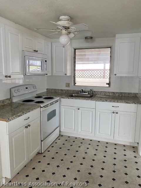 951 Lake June Road Lake Placid, FL 33852 - Photo 6 of 13 a kitchen with granite countertop white cabinets and white appliances