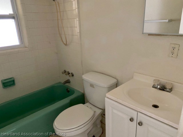 951 Lake June Road Lake Placid, FL 33852 - Photo 8 of 13 a white toilet sitting next to a bathroom sink