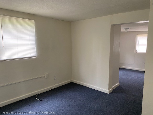 951 Lake June Road Lake Placid, FL 33852 - Photo 10 of 13 an empty room with wooden floor and windows