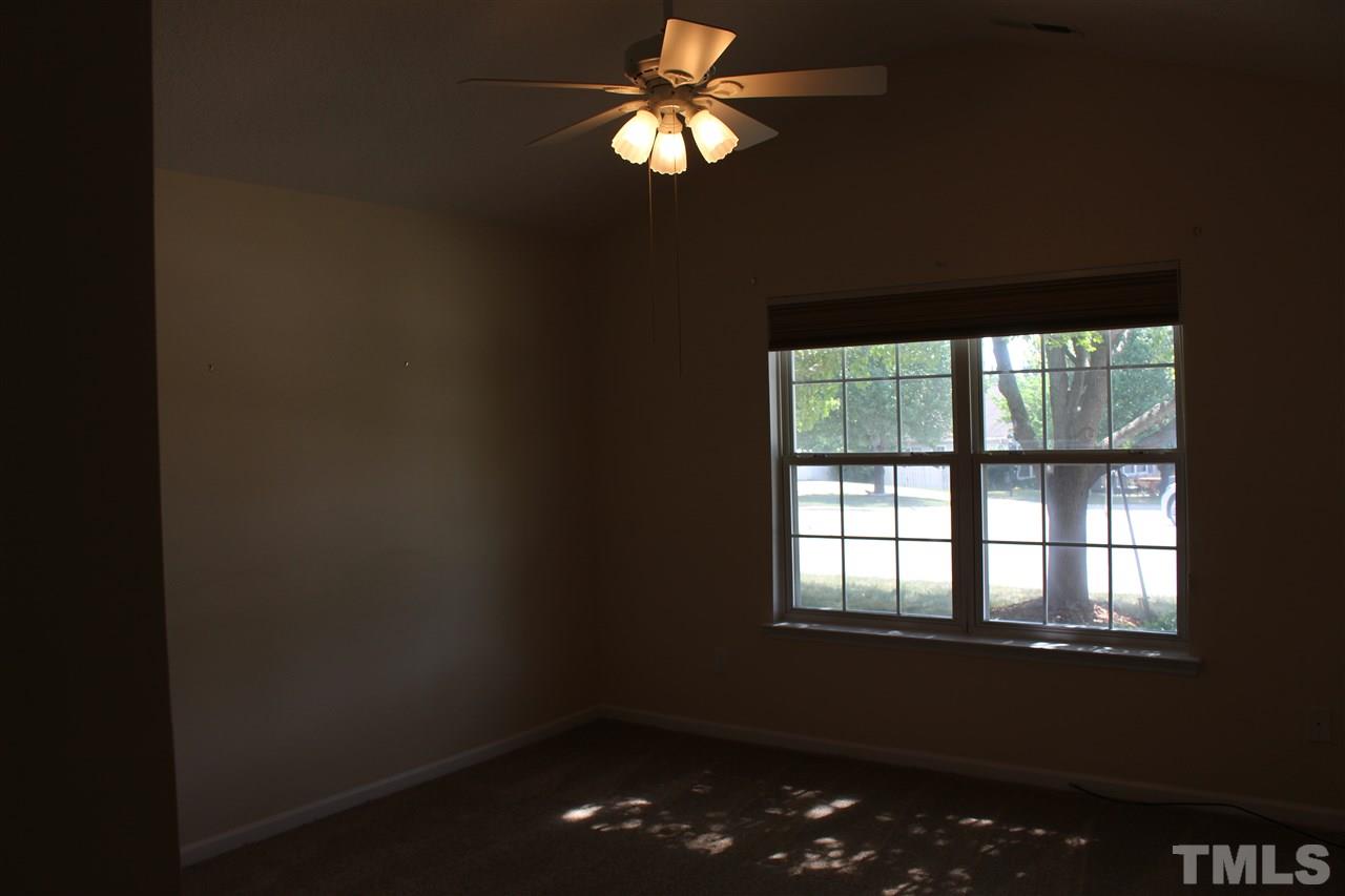 5002 Gable Ridge Drive Durham, NC 27713 - Photo 13 of 16 a lamp on table in an empty room with a window