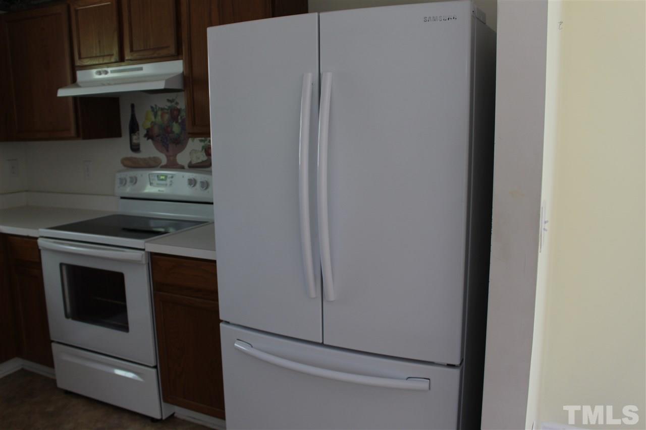 5002 Gable Ridge Drive Durham, NC 27713 - Photo 16 of 16 a kitchen with a stove and a refrigerator