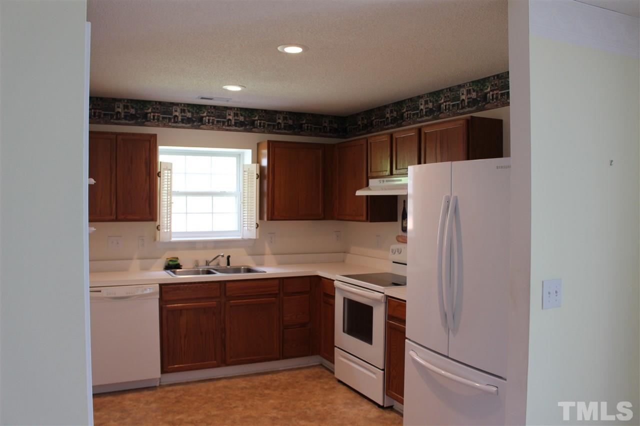 5002 Gable Ridge Drive Durham, NC 27713 - Photo 3 of 16 a kitchen with stainless steel appliances a refrigerator sink and cabinets