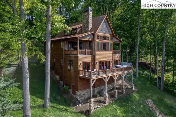 a view of a house with backyard sitting area and garden