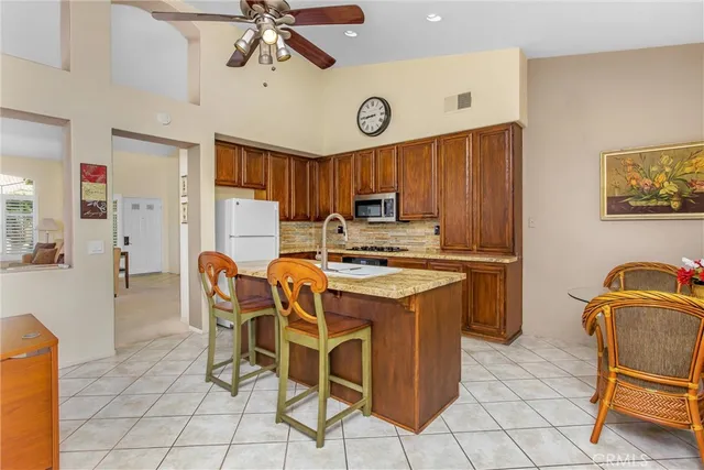 a kitchen that has a table and chairs in it