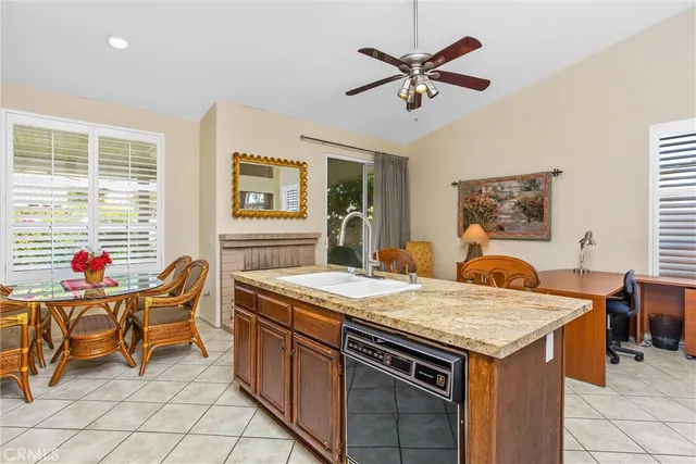 a kitchen with stainless steel appliances granite countertop a refrigerator a sink dishwasher stove with dining table and chairs