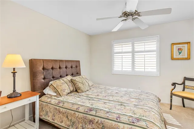 a bedroom with a large bed and a flat tv screen on dresser