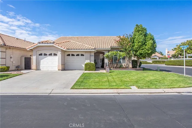 a front view of house with garage and green space