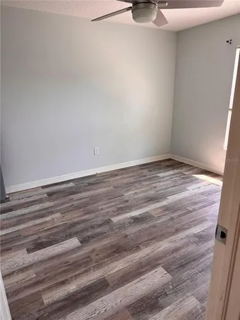 a view of room with hardwood floor and window