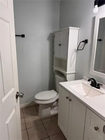 a bathroom with a sink toilet and mirror