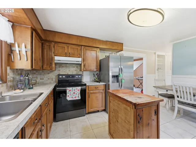 a kitchen with a stove a sink and a refrigerator