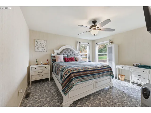 a spacious bedroom with a bed and a chandelier