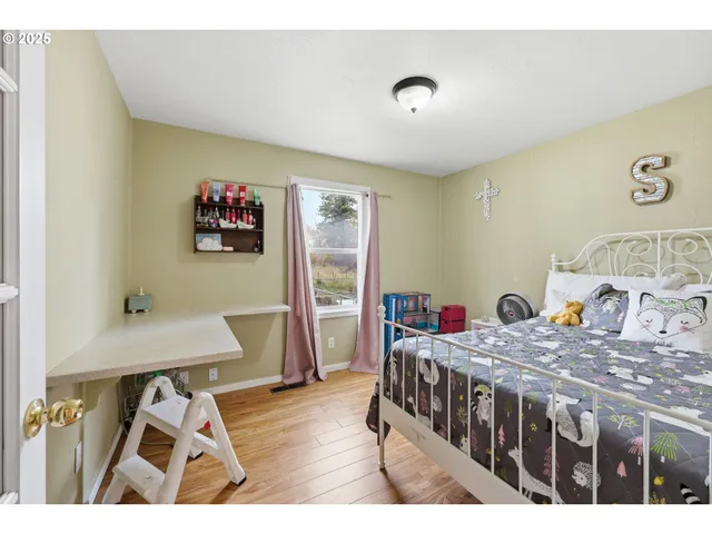 a bedroom with two beds and a desk