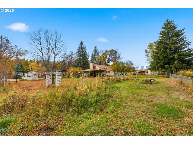 a view of a yard with swimming pool