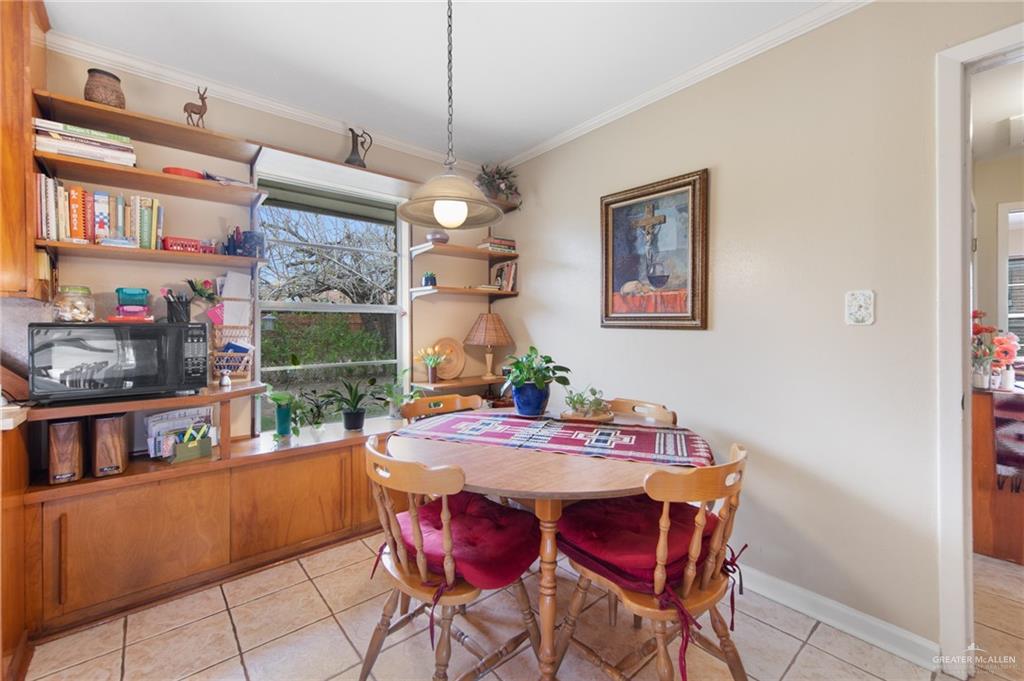 1012 West 3rd Street Weslaco, TX 78596 - Photo 13 of 27 a dining room with a table and chairs