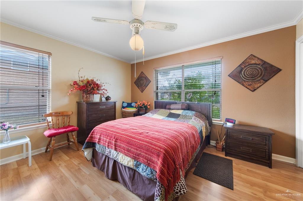 1012 West 3rd Street Weslaco, TX 78596 - Photo 14 of 27 a bedroom with a bed and a table in it