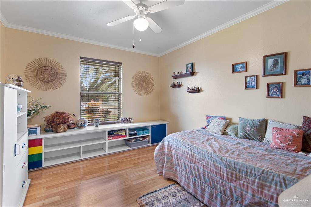 1012 West 3rd Street Weslaco, TX 78596 - Photo 15 of 27 a bedroom with a bed and a chandelier