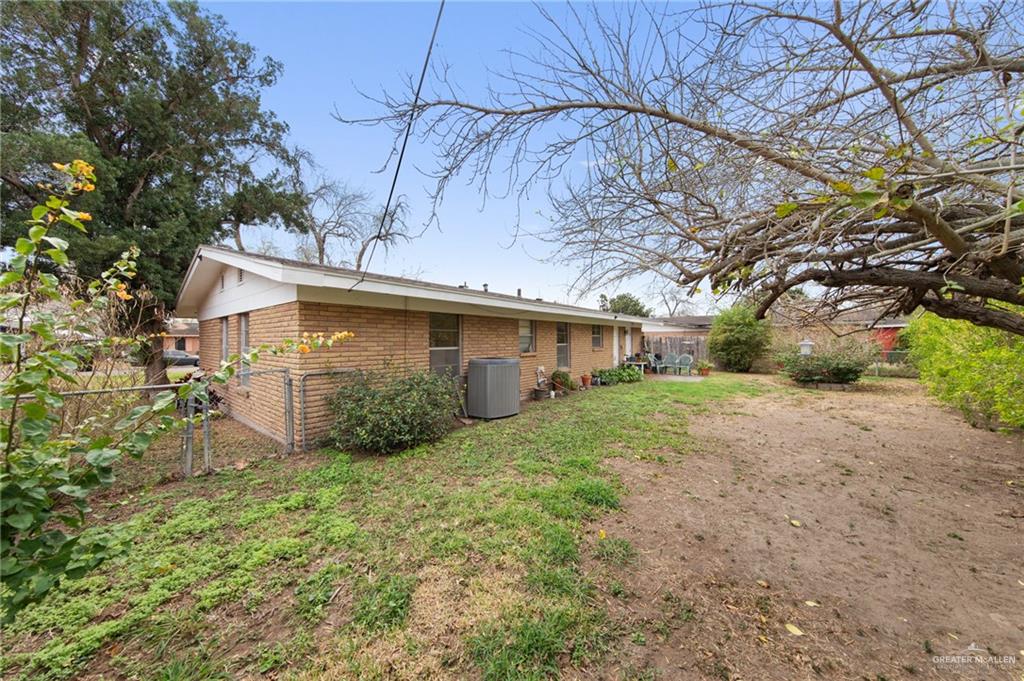 1012 West 3rd Street Weslaco, TX 78596 - Photo 19 of 27 a view of a house with backyard and trees