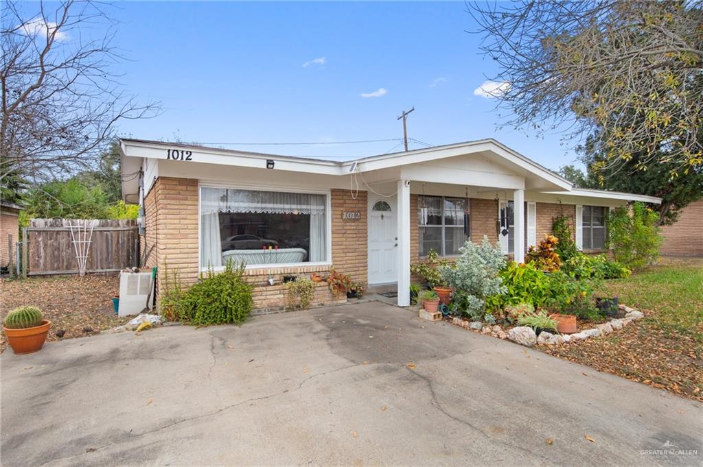 1012 West 3rd Street Weslaco, TX 78596 - Photo 2 of 27 a front view of a house with garden