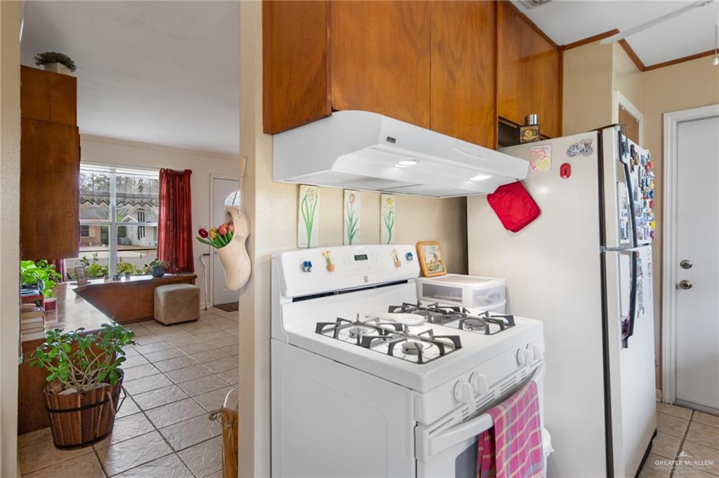 1012 West 3rd Street Weslaco, TX 78596 - Photo 10 of 27 a kitchen with a refrigerator and a stove