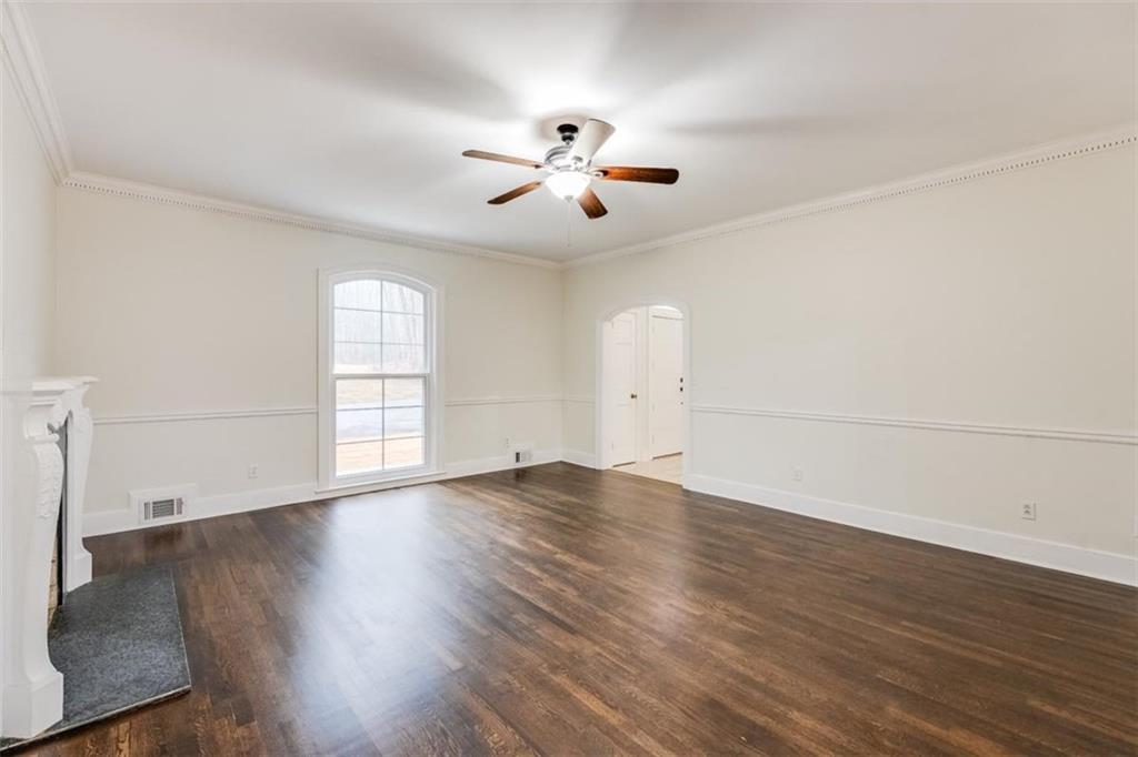 5550 Koweta Road South Fulton, GA 30349 - Photo 16 of 58 an empty room with wooden floor and windows