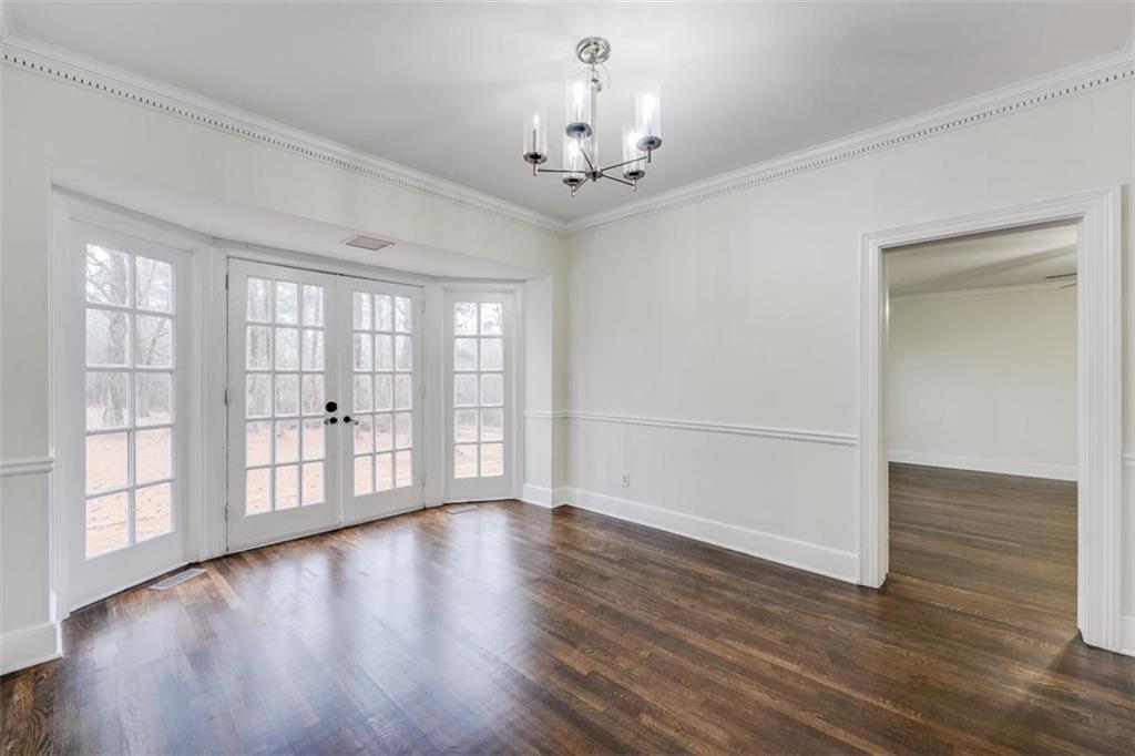 5550 Koweta Road South Fulton, GA 30349 - Photo 17 of 58 a view of an empty room with wooden floor and a window
