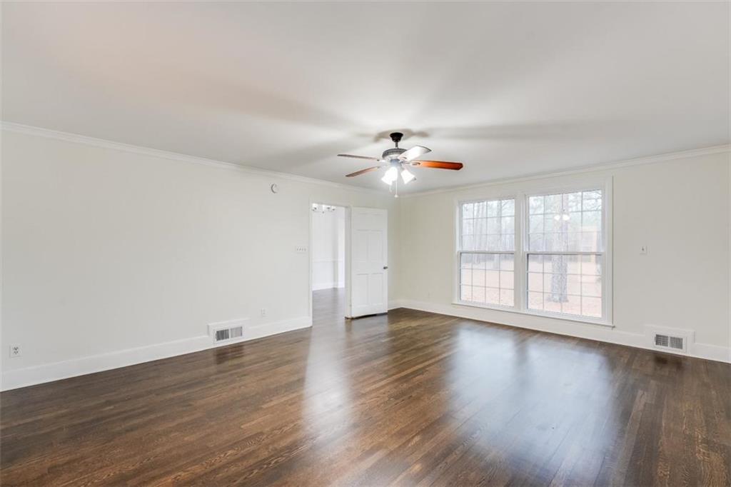 5550 Koweta Road South Fulton, GA 30349 - Photo 18 of 58 a view of an empty room with wooden floor and a window