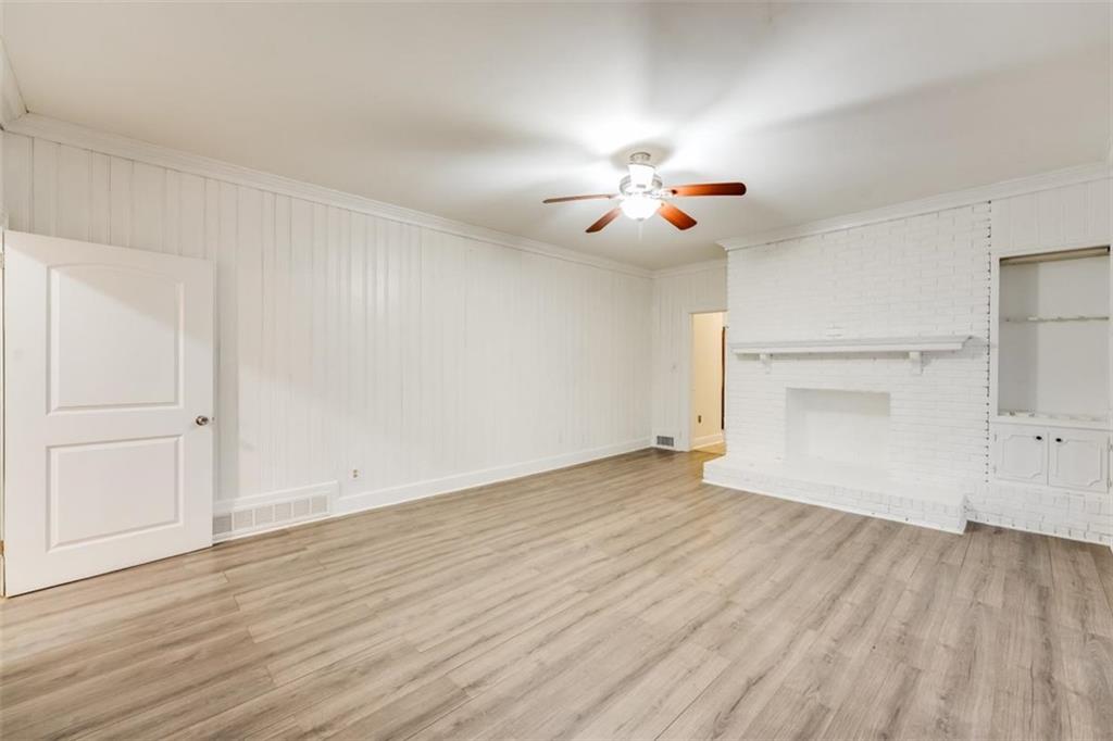 5550 Koweta Road South Fulton, GA 30349 - Photo 23 of 58 an empty room with wooden floor chandelier fan and windows