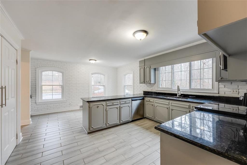 5550 Koweta Road South Fulton, GA 30349 - Photo 24 of 58 a kitchen with granite countertop cabinets stainless steel appliances a sink and a window