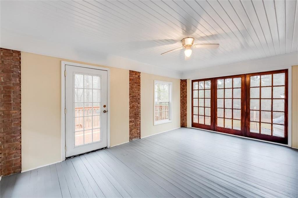 5550 Koweta Road South Fulton, GA 30349 - Photo 37 of 58 an empty room with wooden floor fan and windows