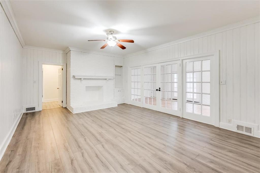 5550 Koweta Road South Fulton, GA 30349 - Photo 46 of 58 an empty room with wooden floor chandelier fan and windows