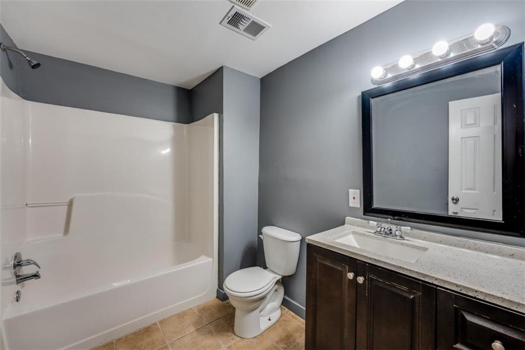 5550 Koweta Road South Fulton, GA 30349 - Photo 55 of 58 a bathroom with a sink and a mirror