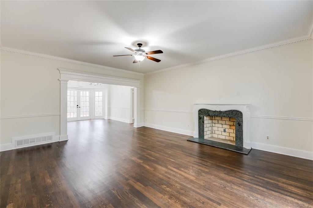 5550 Koweta Road South Fulton, GA 30349 - Photo 6 of 58 a view of an empty room with wooden floor and a window