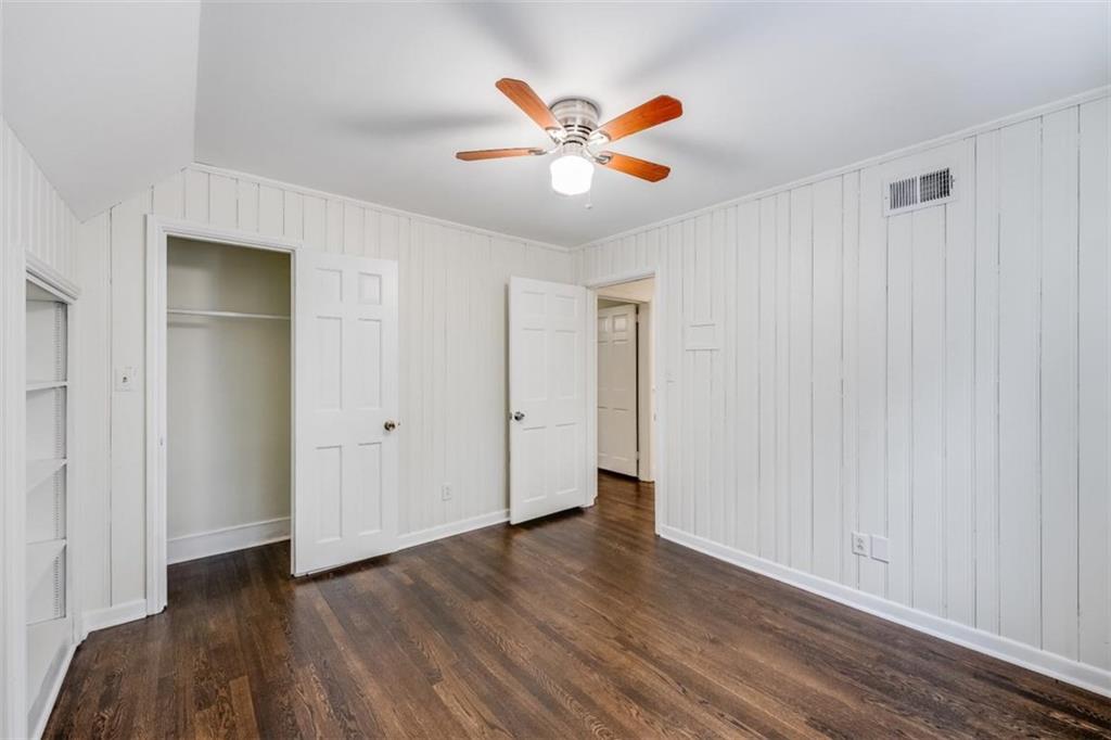 5550 Koweta Road South Fulton, GA 30349 - Photo 9 of 58 a view of an empty room with wooden floor and a ceiling fan