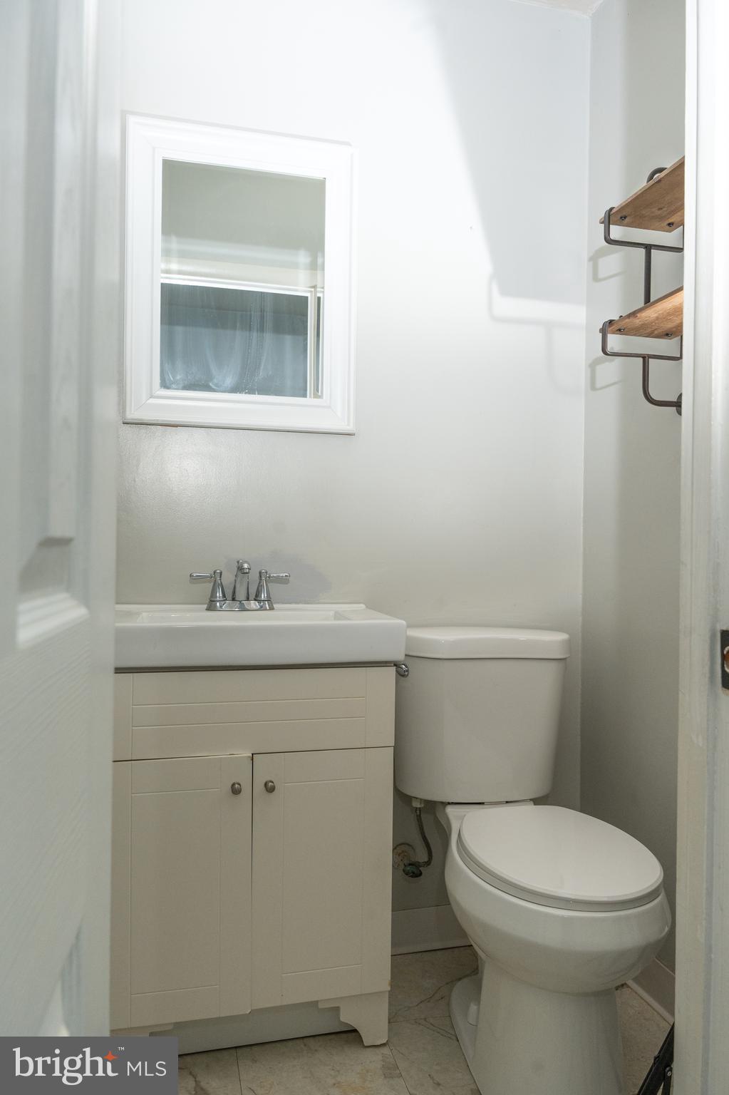 1151 Morefield Road Philadelphia, PA 19115 - Photo 9 of 22 a bathroom with a toilet a sink and mirror
