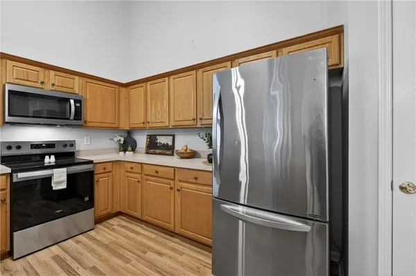 a kitchen with stainless steel appliances granite countertop a refrigerator a stove top oven a sink and dishwasher