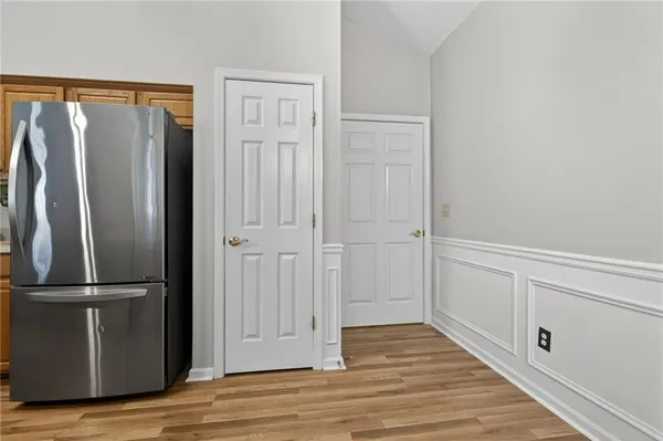 a view of a refrigerator in kitchen and wooden floor