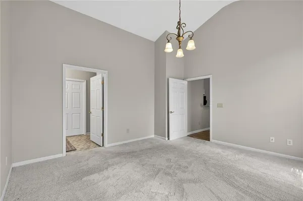 a view of a chandelier fan and entryway